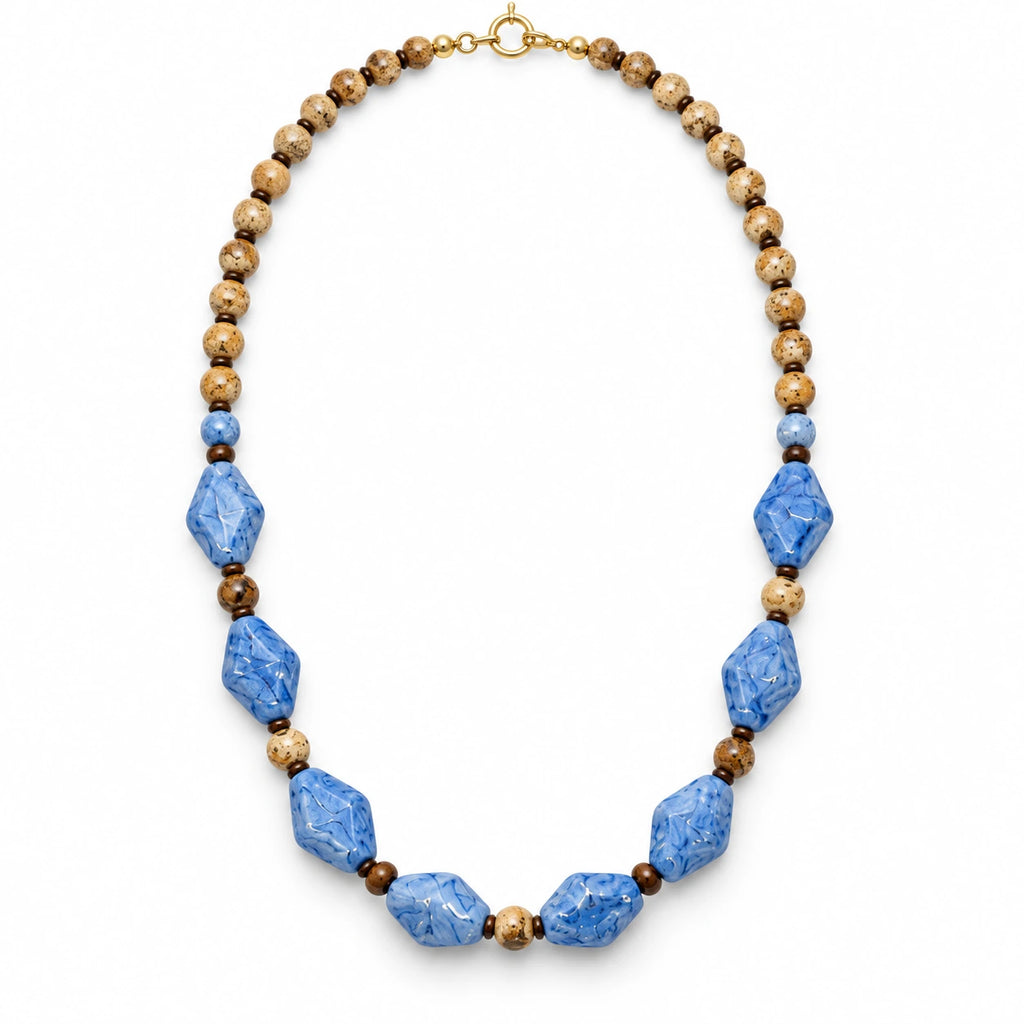 Caelum — blue geometric beaded necklace by ArtsWeave, isolated on a white background