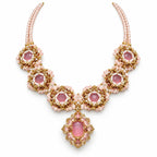 Rosera — pink floral medallion necklace by ArtsWeave, isolated on a white background