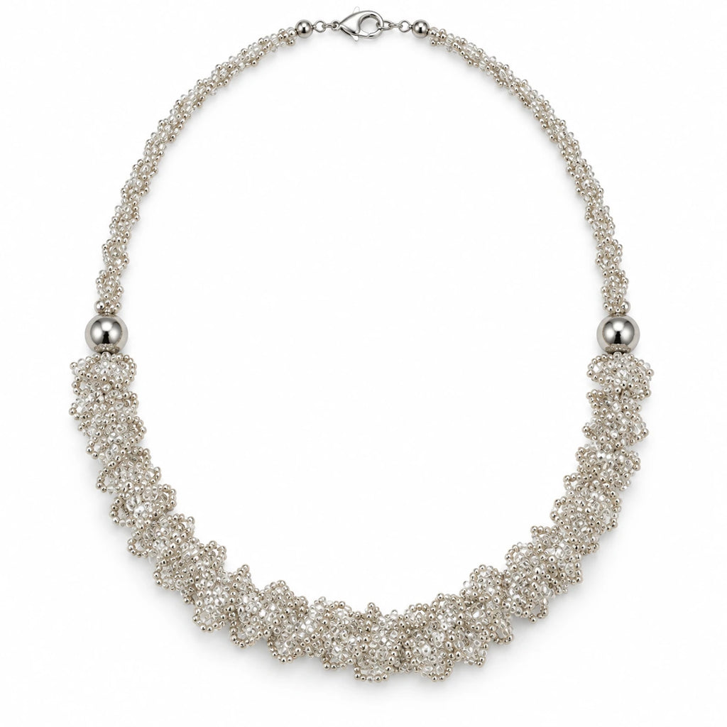 Veil — silver-tone ruffled beaded necklace by ArtsWeave, isolated on a white background